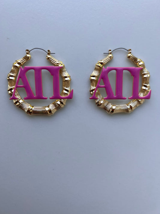 gold bamboo hoop earrings with pink ATL letters in the center